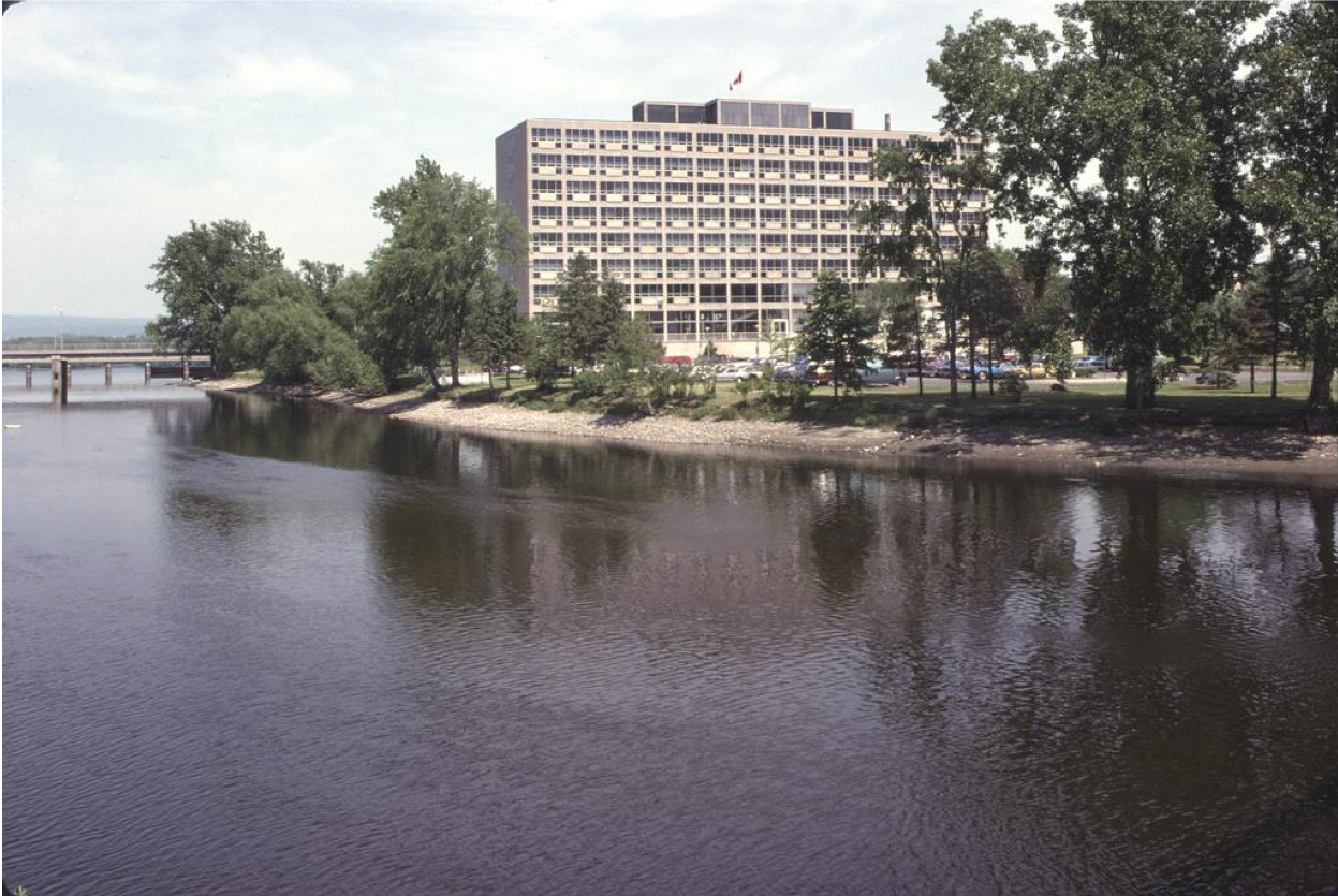 Diefenbaker Building 57 - exterior view across Riodeau River of 1958 building from south