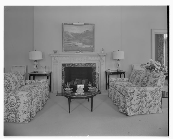 Interior of 24 Sussex Drive with a fireplace and two couches