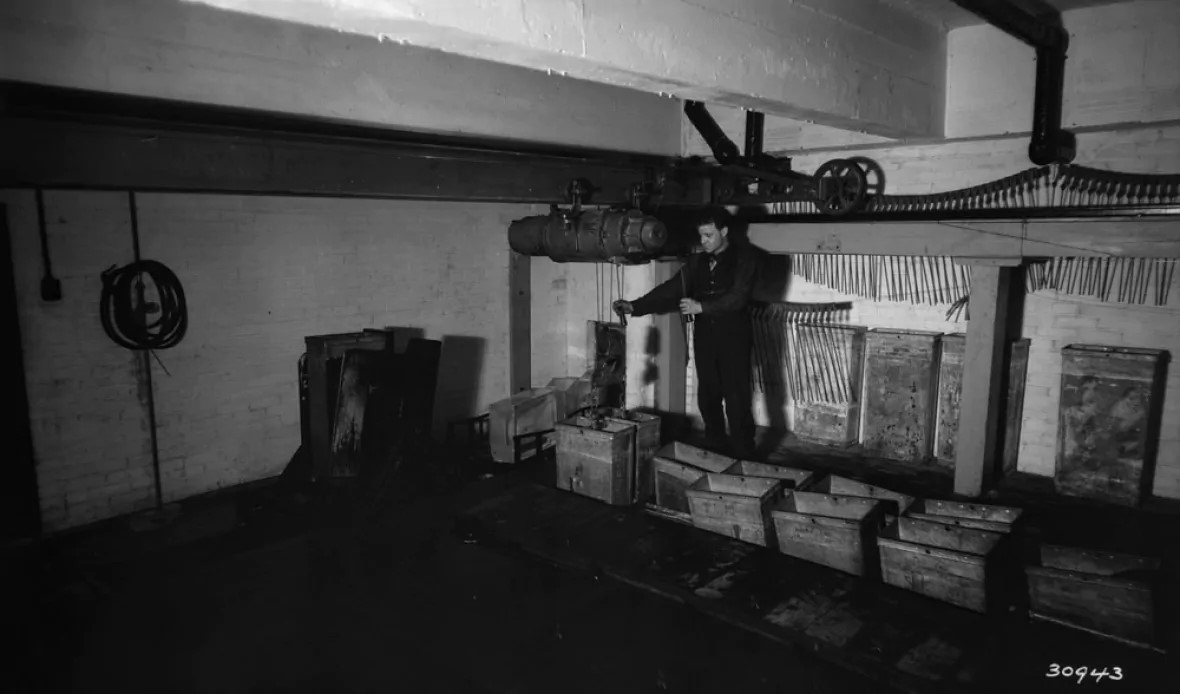 A man works inside the Château Laurier's icemaking room in this photo from 1929. (Library and Archives Canada)
