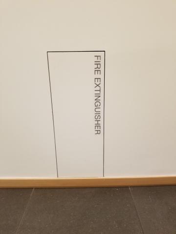 Detail of fire hydrant placed along the bottom of the wall