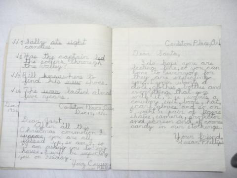 Green School notebook with "Susan Phillips / Victoria School / Grade IV / English" Spelling and writing exercises inside.